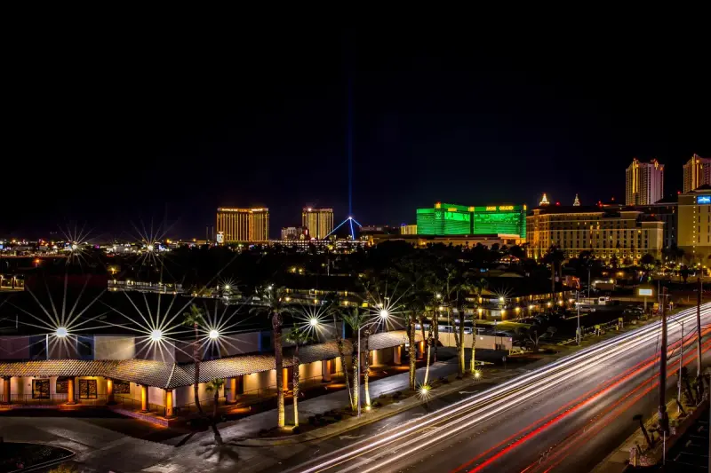 Las Vegas Strip at night with glowing resort towers and car light trails