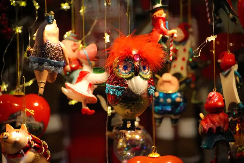 Whimsical hanging Christmas ornaments shaped as birds, animals and figures in red and gold