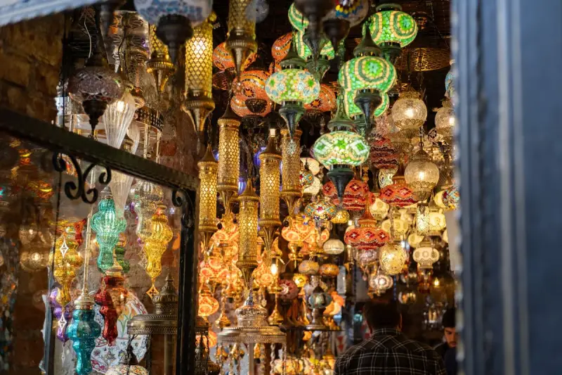 Hundreds of colorful mosaic glass lamps glowing from the ceiling of a lighting shop