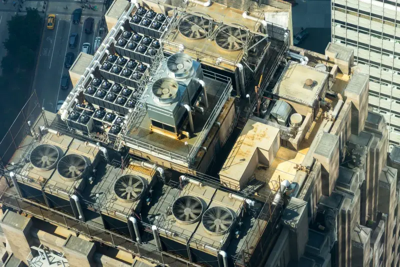 Aerial view of rooftop cooling fans and mechanical units on a city building