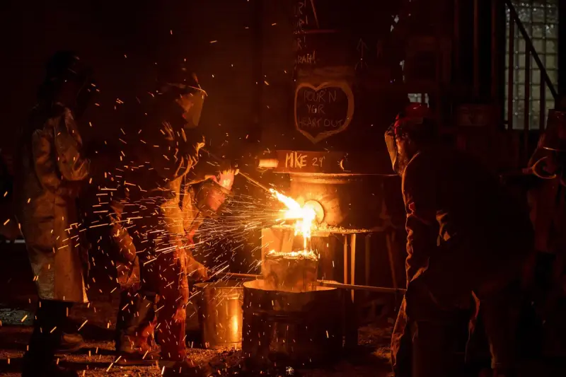 Metalworkers in protective gear at work inside a Milwaukee foundry