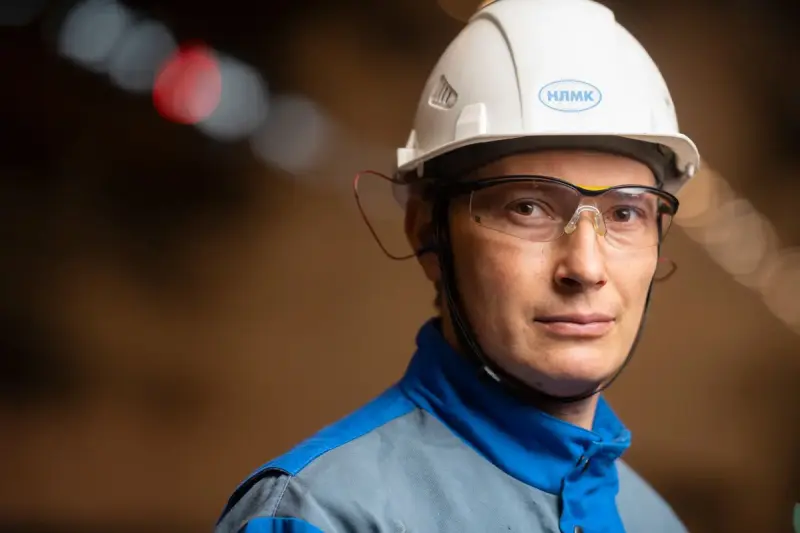 Engineer in a helmet and safety goggles working in an industrial plant