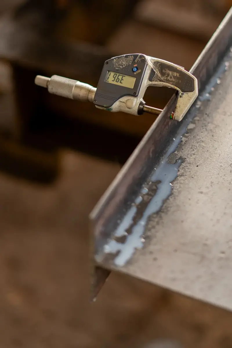 Digital micrometer measuring the thickness of a metal sheet