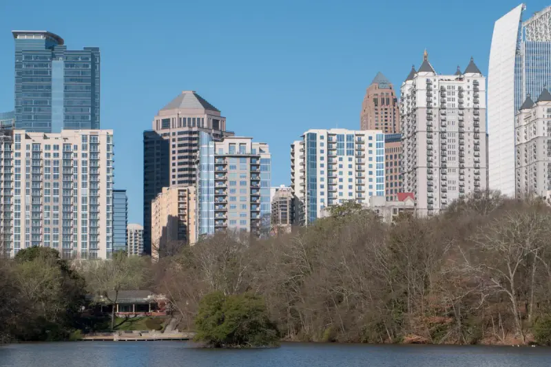 Midtown Atlanta skyline rising above Lake Clara Meer in Piedmont Park