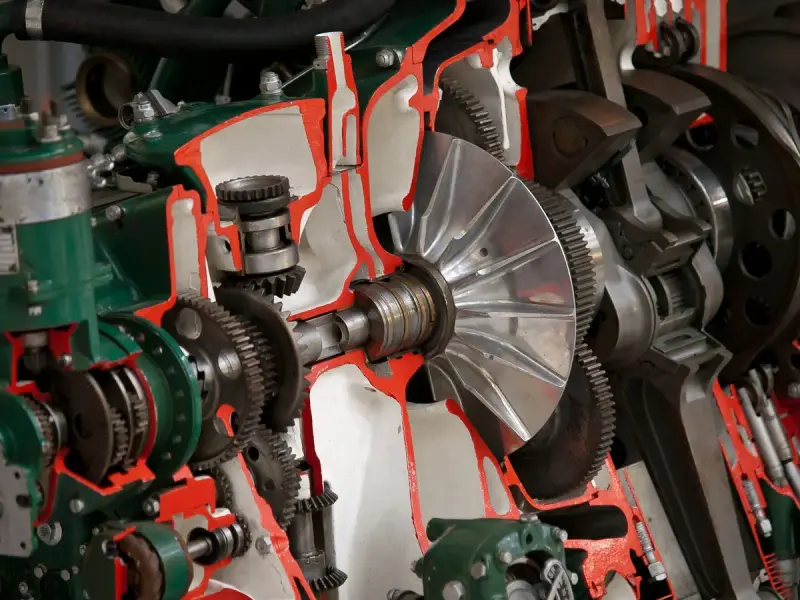 Cutaway of a gearbox showing a turbine wheel, shafts and gears painted red and green
