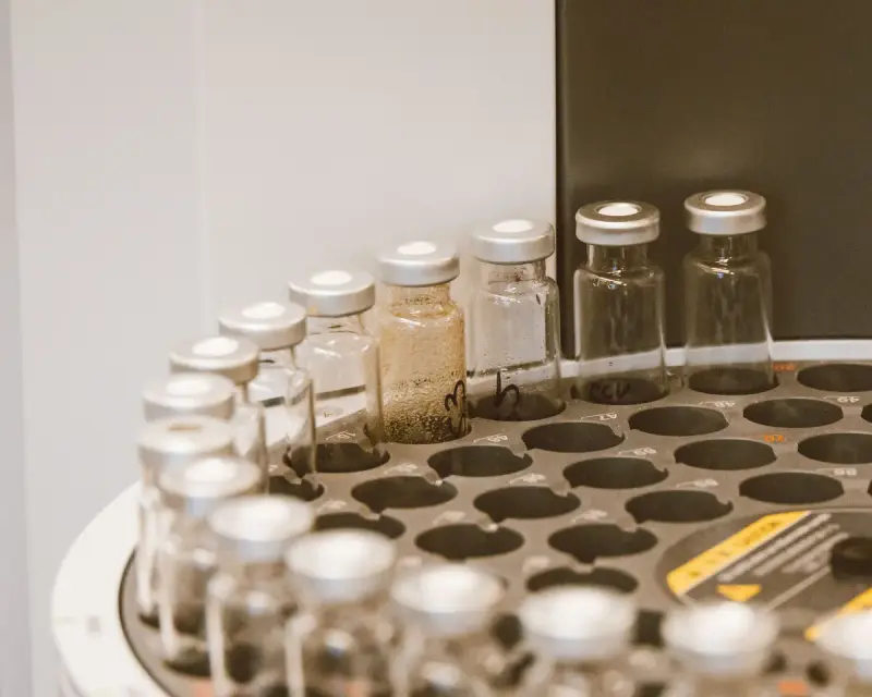 Glass sample vials standing in a laboratory rack