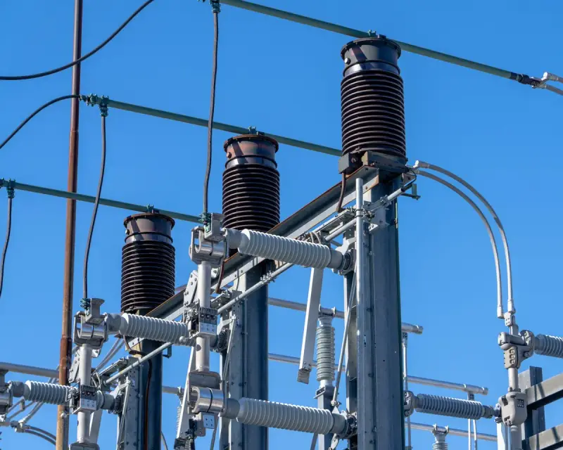 Electrical components in a high-voltage substation under a clear sky