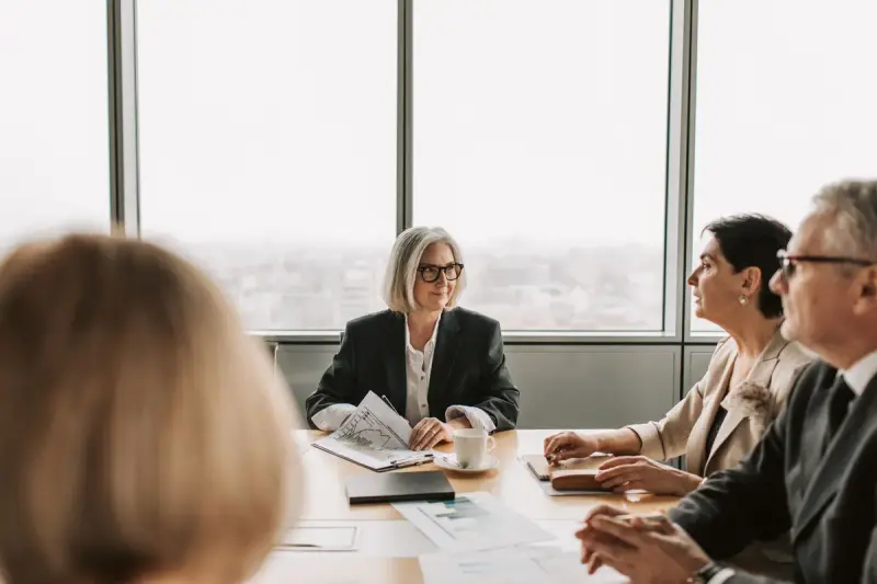 Group of professionals in a business meeting around a table