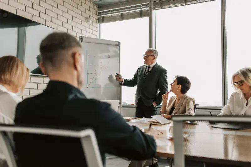 Senior leader presenting to colleagues in an office meeting