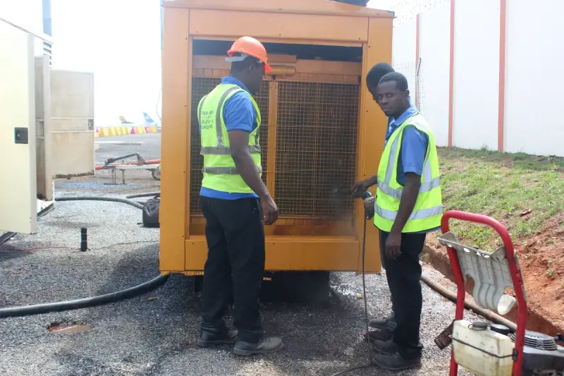 Two technicians servicing a diesel generator set together