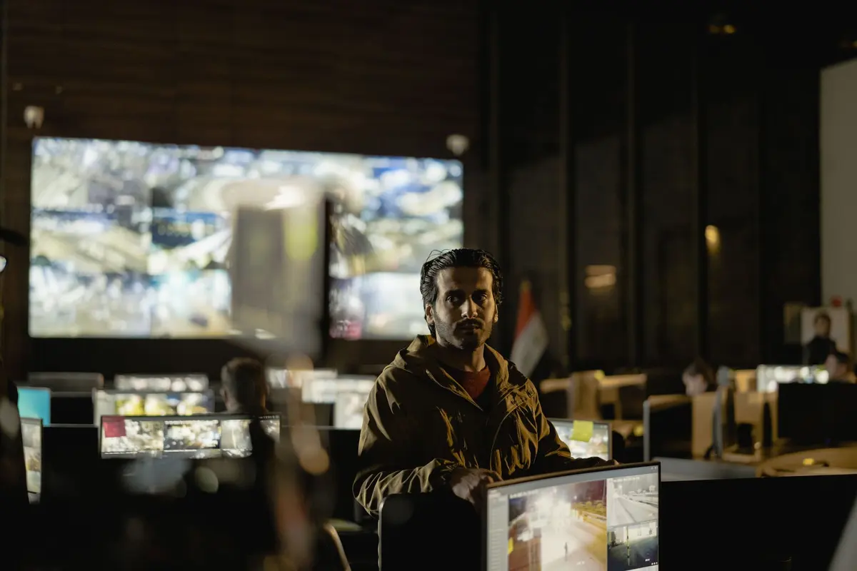 Team of operators monitoring live surveillance feeds in a security control room