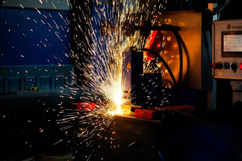 Sparks bursting from an industrial welding machine in a factory