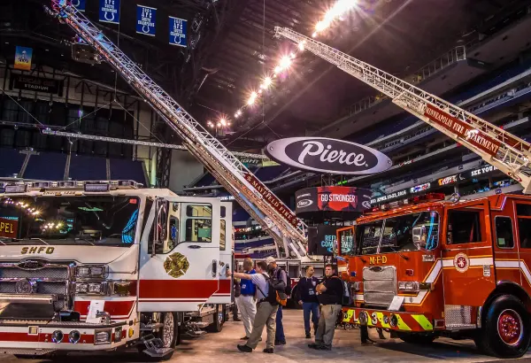 Visitors and exhibitors beside fire apparatus at FDIC 2015 in Indianapolis.