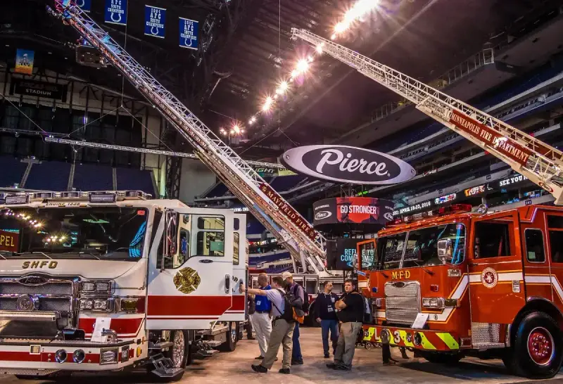 Visitors and exhibitors beside fire apparatus at FDIC 2015 in Indianapolis.