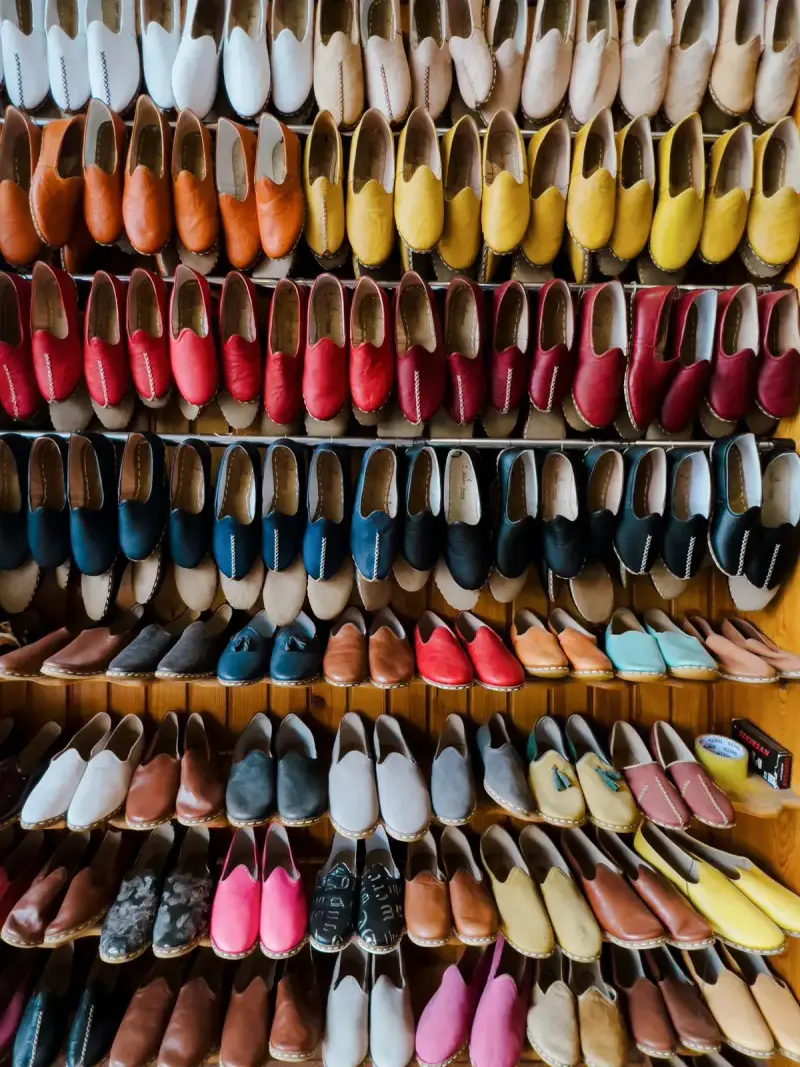 Rows of colorful leather flats and loafers on store shelves