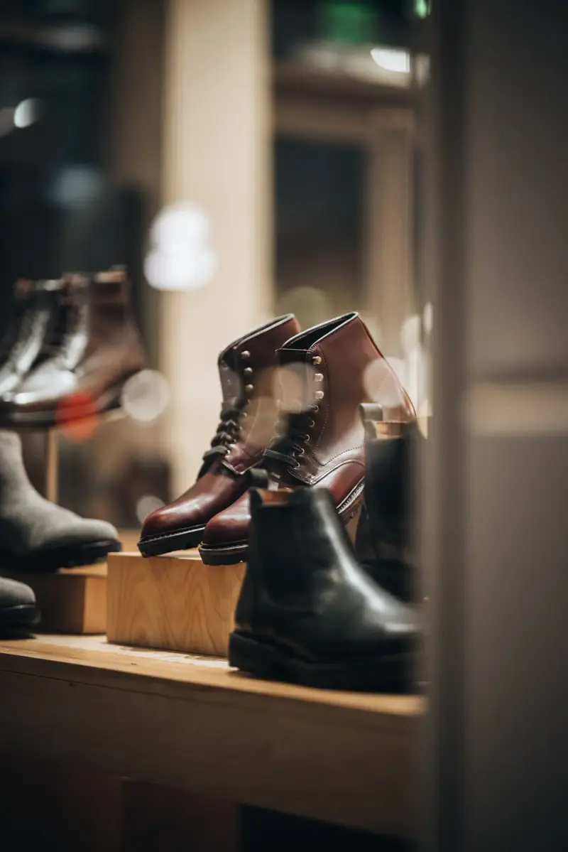 Leather boots on a window display seen through glass