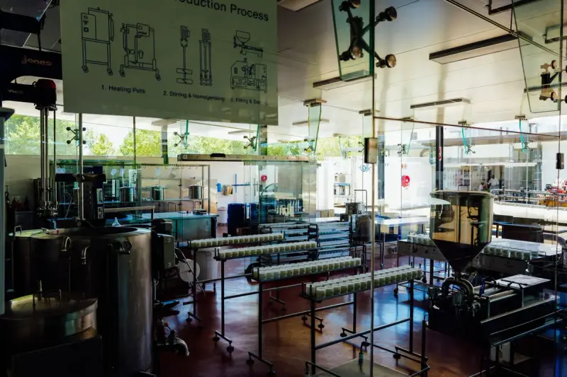 Spacious food production plant interior with stainless processing machinery and a line