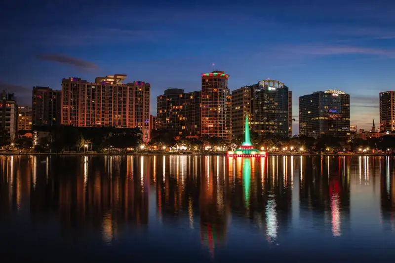The Orlando skyline at dusk reflected in Lake Eola