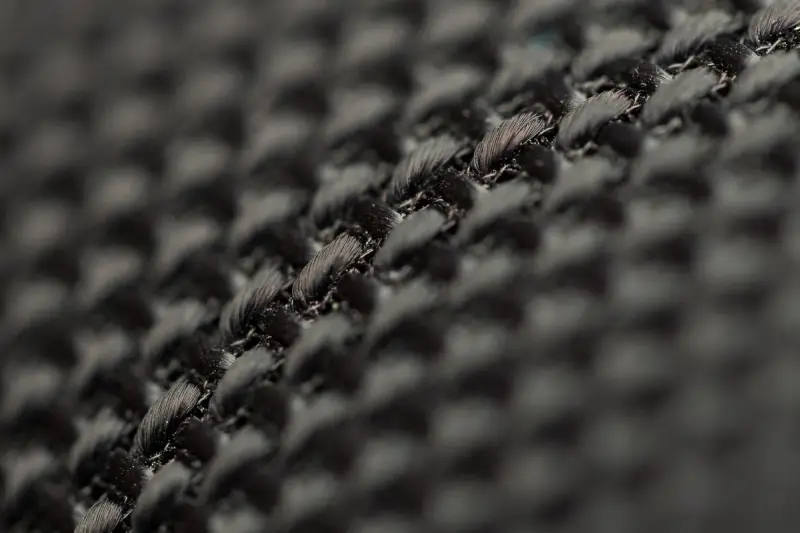 Close-up of a tight black woven fabric showing its weave