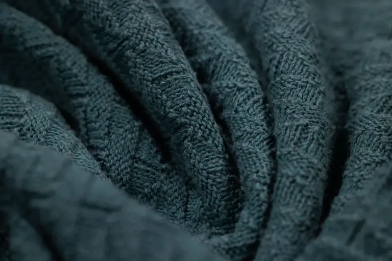Macro view of a textured blue knitted fabric