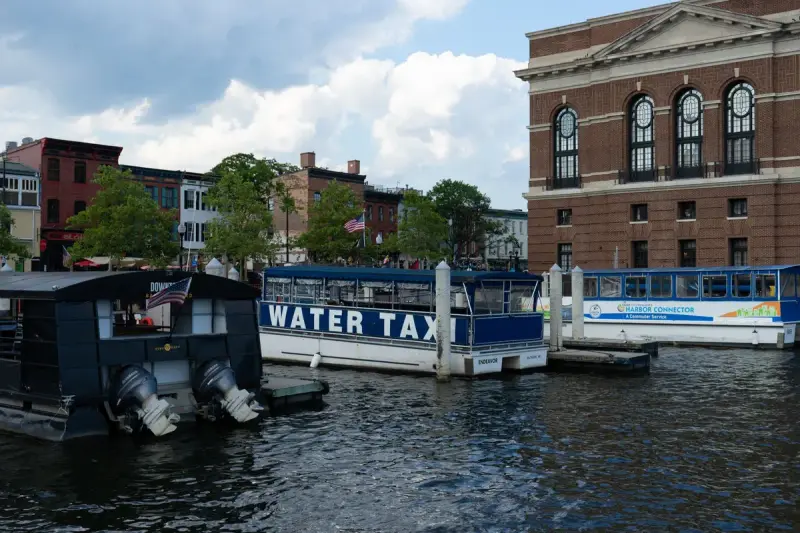Water taxis moored along the historic brick waterfront of Fells Point in Baltimore