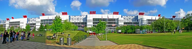 Panorama of the full George R. Brown Convention Center facade seen from Discovery Green park in Houston