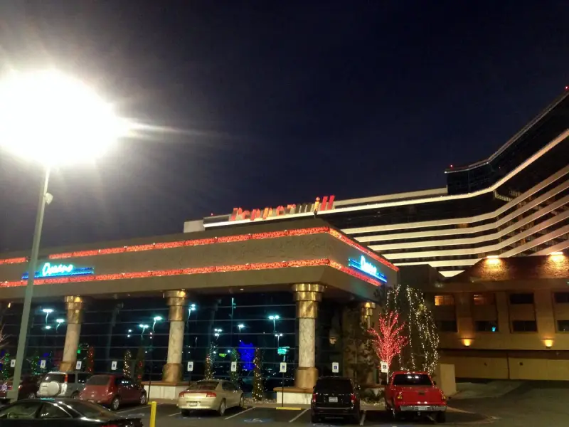 Lit entrance canopy and hotel tower of the Peppermill Resort in Reno, Nevada, at night