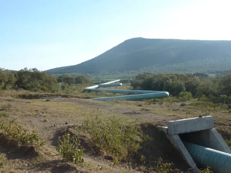 Insulated geothermal steam pipelines running across a valley floor