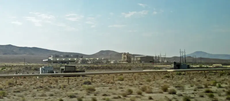 Geothermal power plant buildings and pipes at Brady's Hot Springs in the Nevada desert