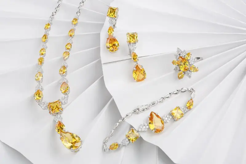 Citrine and diamond necklace, earrings and bracelet set on white paper fans