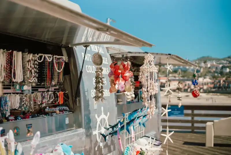 Seaside stall hung with shell necklaces, wind chimes and beach souvenirs