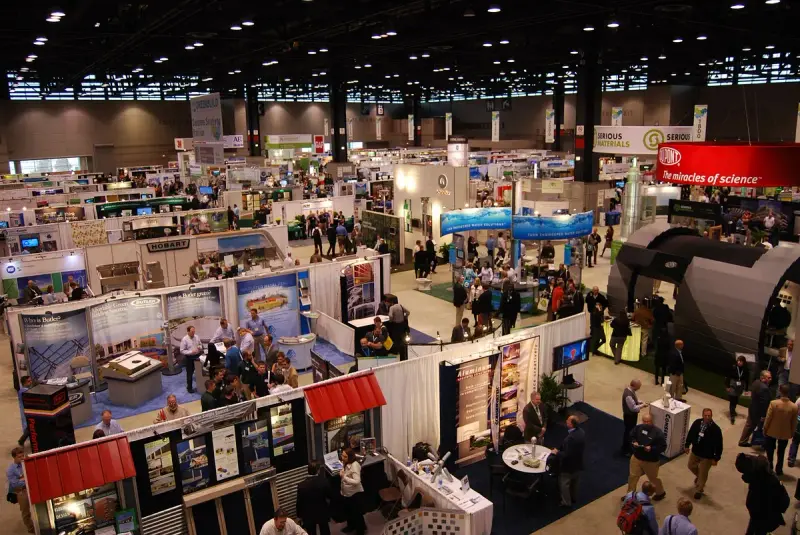Greenbuild expo floor at McCormick Place seen from above, with rows of booths and visitors in the aisles