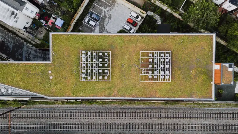 Aerial view of a green lawn roof on a Philadelphia building among city rooftops