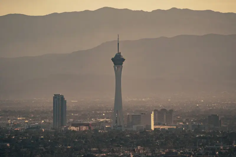 Las Vegas skyline at dusk with the Strat tower against desert mountains