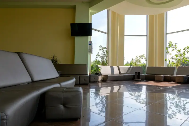 Spacious lobby with modern furniture and tall windows letting in daylight