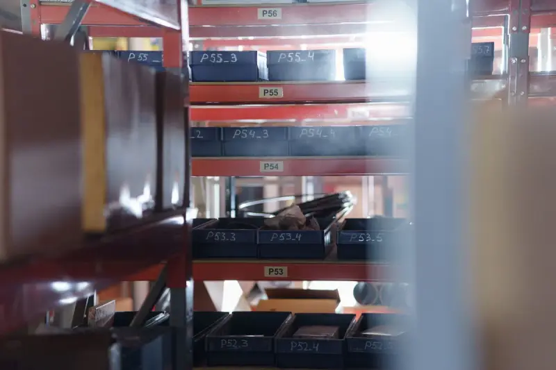 Numbered storage bins on warehouse shelving for picking small items
