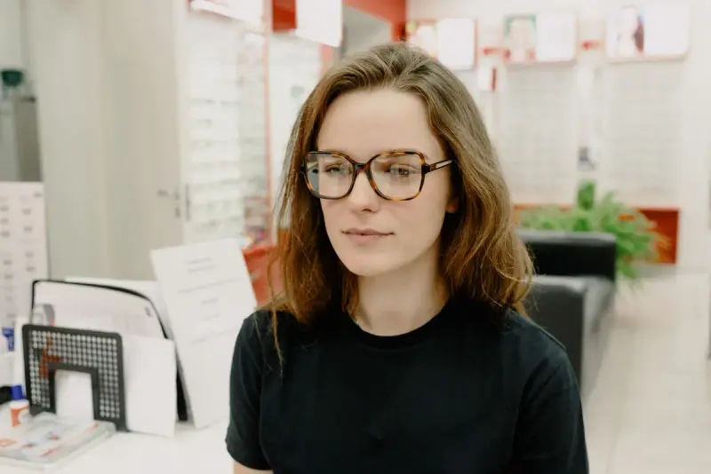Woman trying new tortoiseshell eyeglasses in an optical store