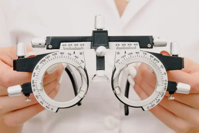 Optometrist's hands holding a trial lens frame