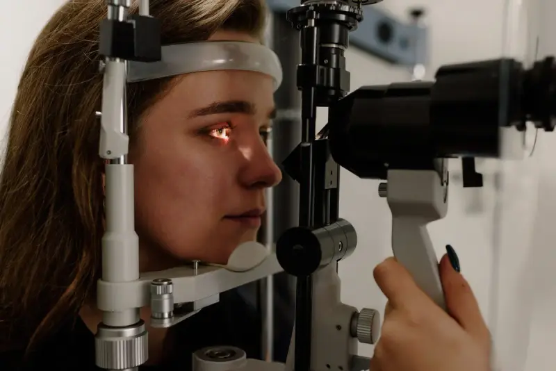 Woman having an eye examination at a slit lamp in a modern clinic