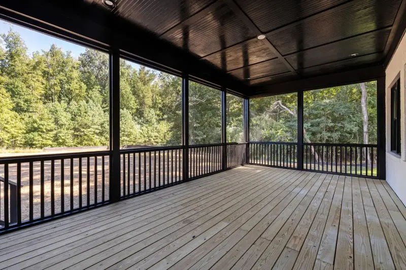 Large wooden patio deck facing a green forest