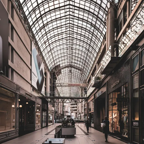 Shopping mall interior beneath a broad glass ceiling