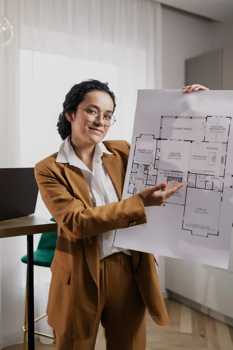 Woman presenting a detailed architectural floor plan