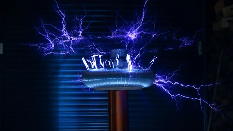 Electric arcs leaping from a Tesla coil in a dark room