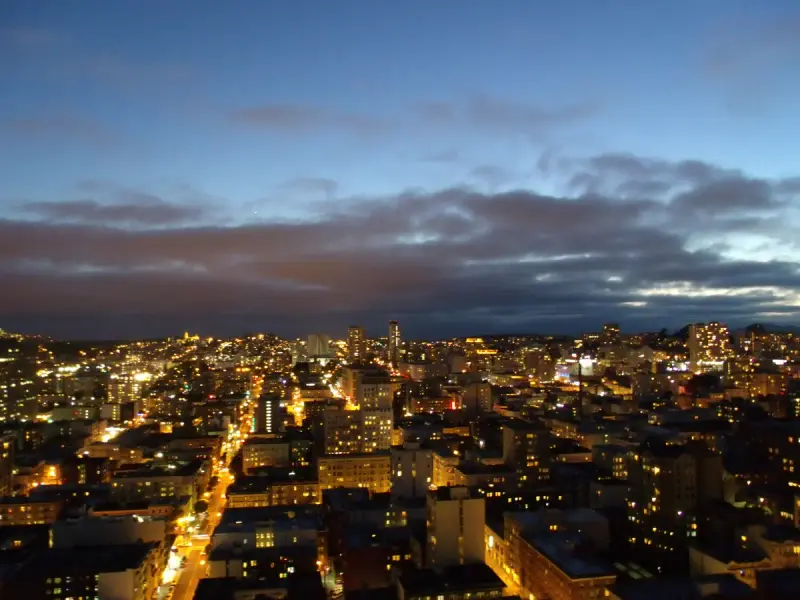 San Francisco's streets lit up at dusk, seen from a high floor near Union Square
