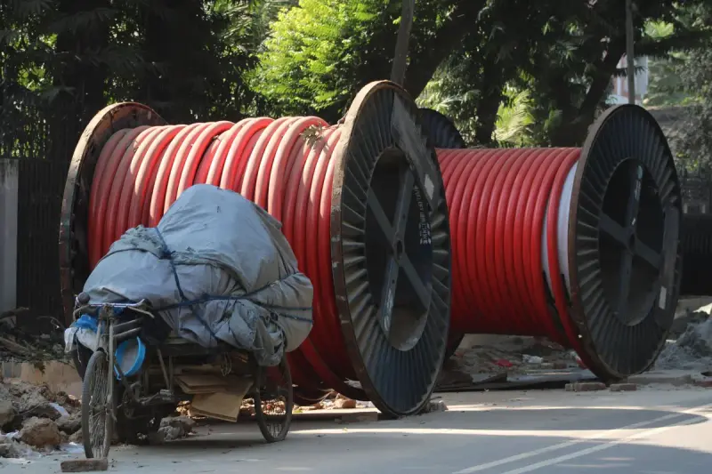 Large red industrial cable reels on a construction site
