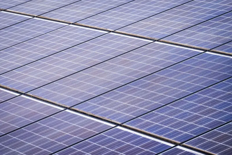 Close-up of a solar panel array catching bright sunlight