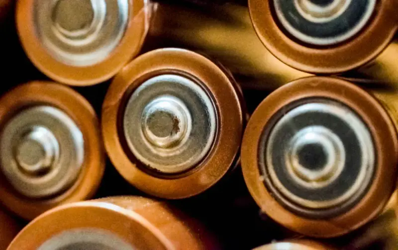 Close-up of the terminal ends of grouped cylindrical battery cells