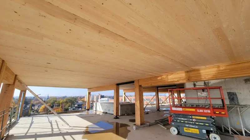 Building under construction with a wooden structural frame on site