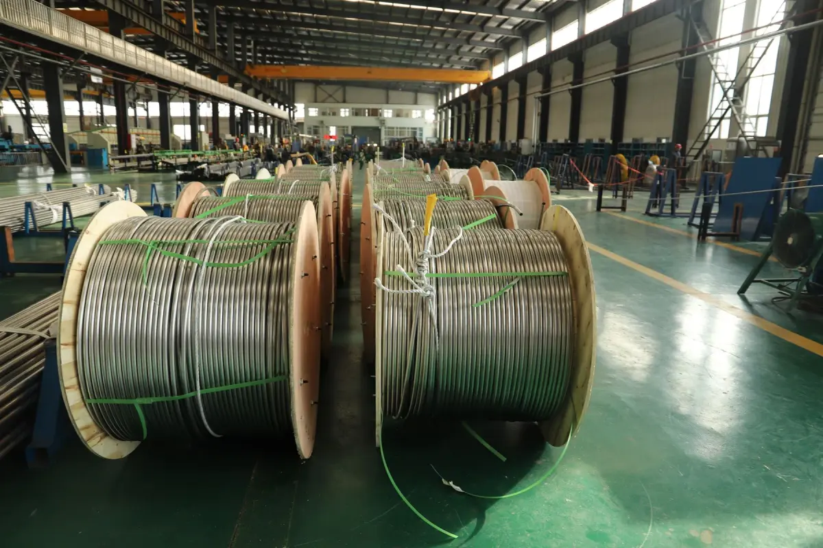 Large coiled industrial materials inside a manufacturing facility.