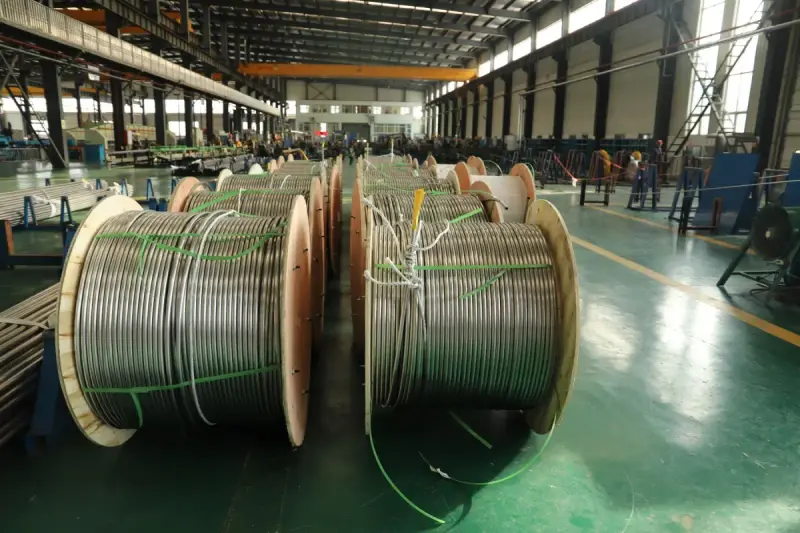 Large coiled industrial materials inside a manufacturing facility.